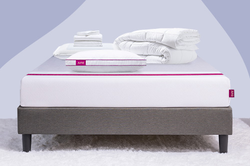 A series of bedding items and pillows lay on top of a Juno mattress for the Build a Bundle promotion. 