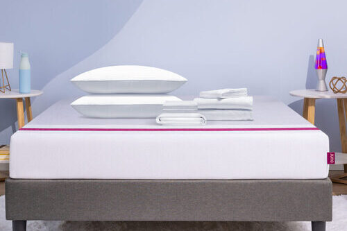 A series of bedding items and pillows lay on top of a Juno mattress for the Build a Bundle promotion. 